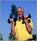 older man lifting weights outdoors