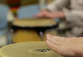 hands playing conga drum