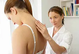 woman getting spine examined