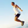 man jumping rope on beach