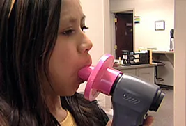 young girl using inhaler