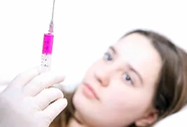 girl looking at syringe