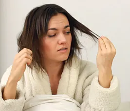 woman looking at hair