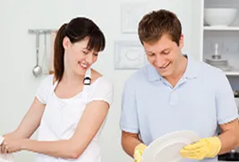 woman and man washing dishes