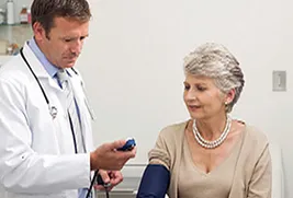 doctor checking blood pressure