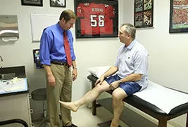man showing doctor his knee