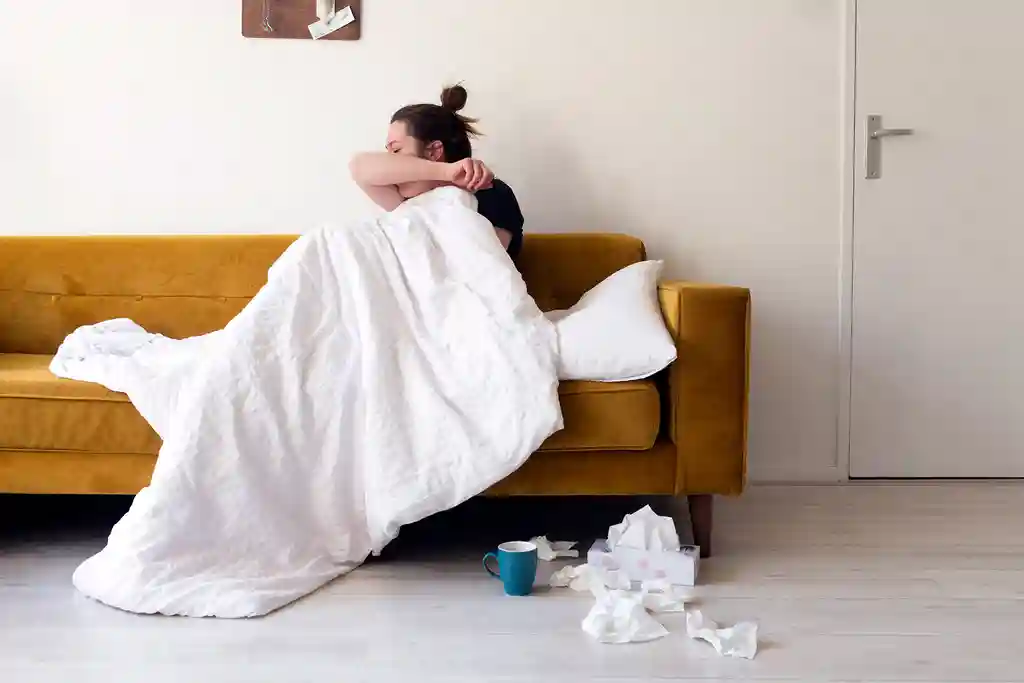 photo of woman feeling sick in a living room