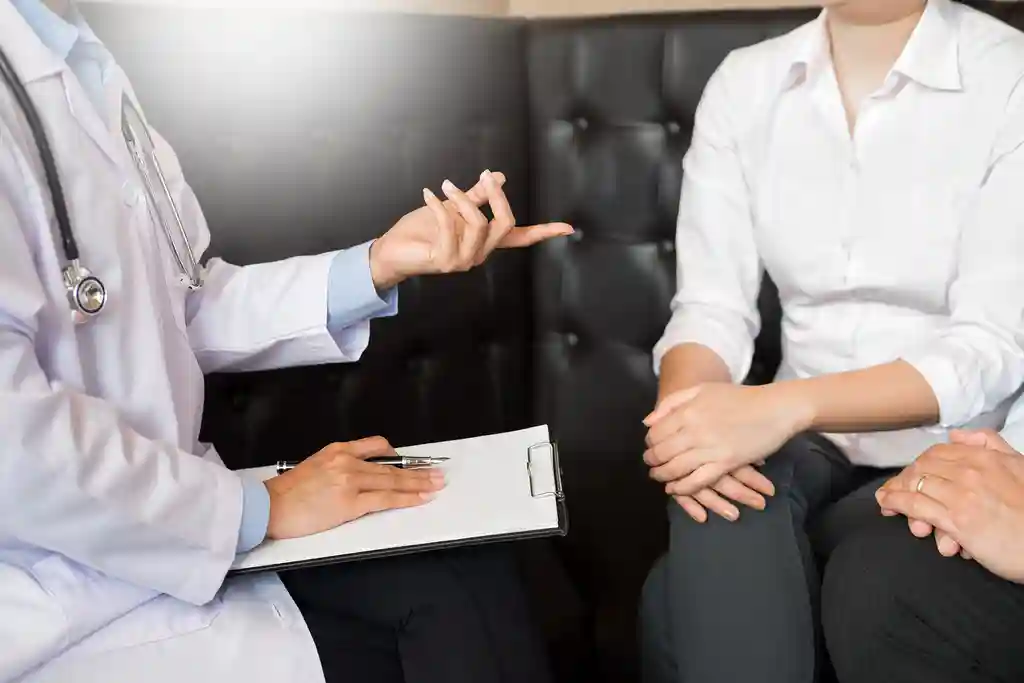 photo of female doctor talking with patient