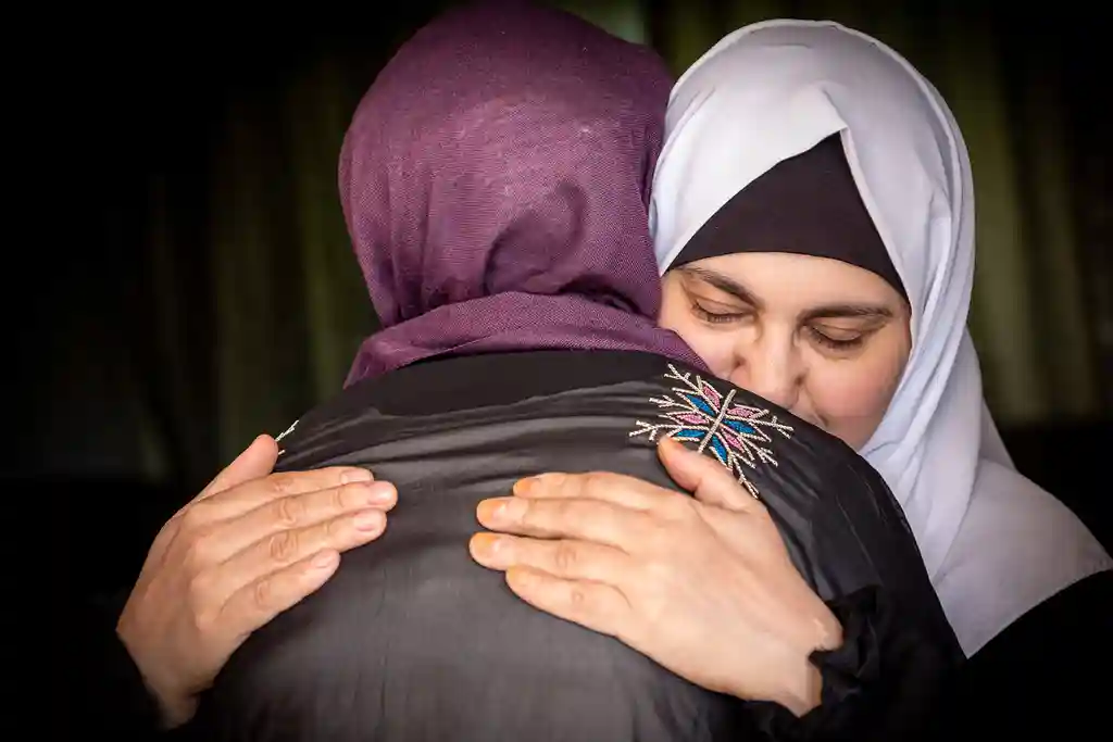 photo of two muslim woman embracing