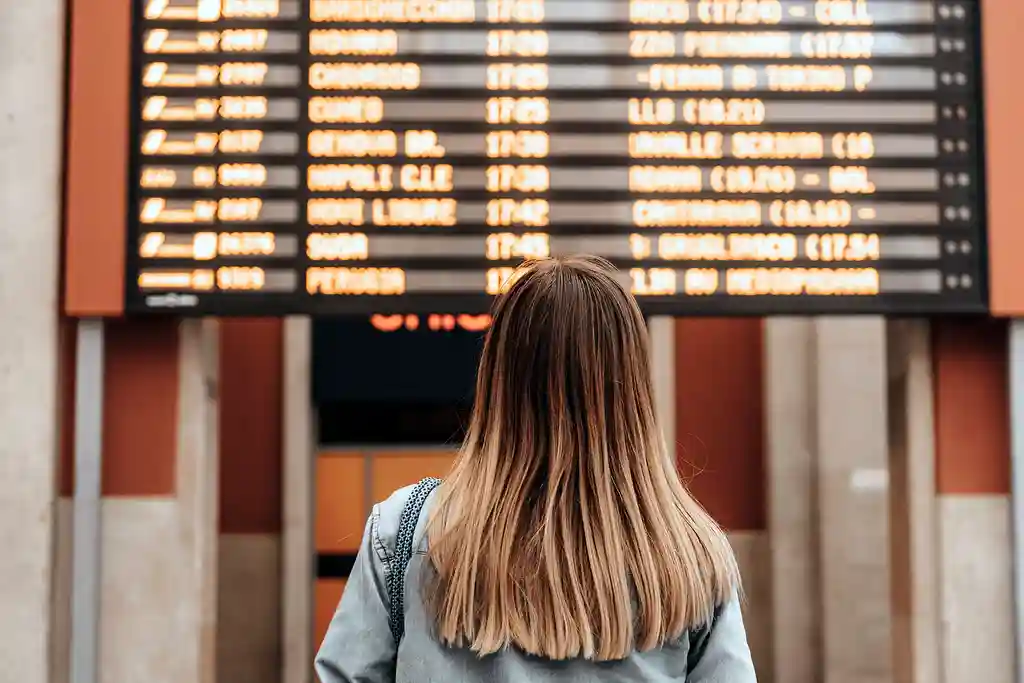 photo of young woman at railway station or airport