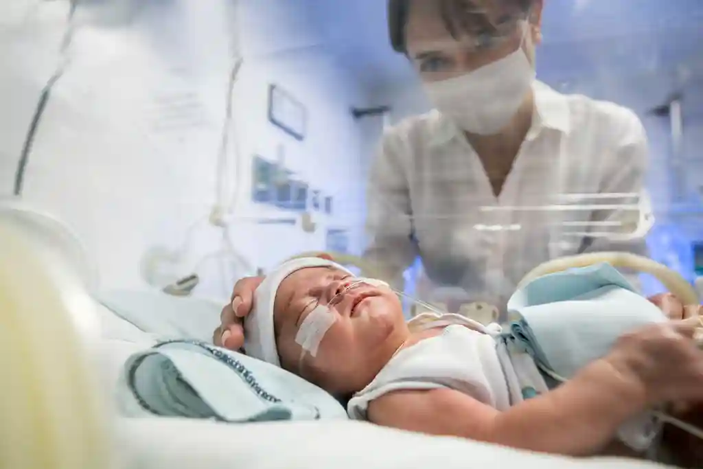 photo of mother looking at child in incubator