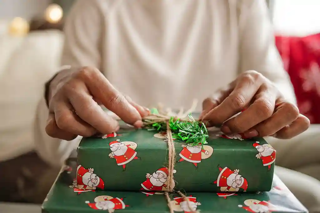 photo of woman's hands on christmas gifts