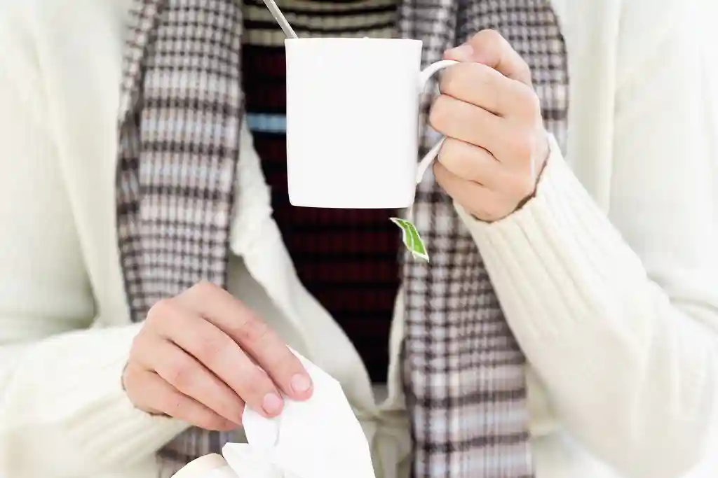 photo of woman getting tissue and drinking tea