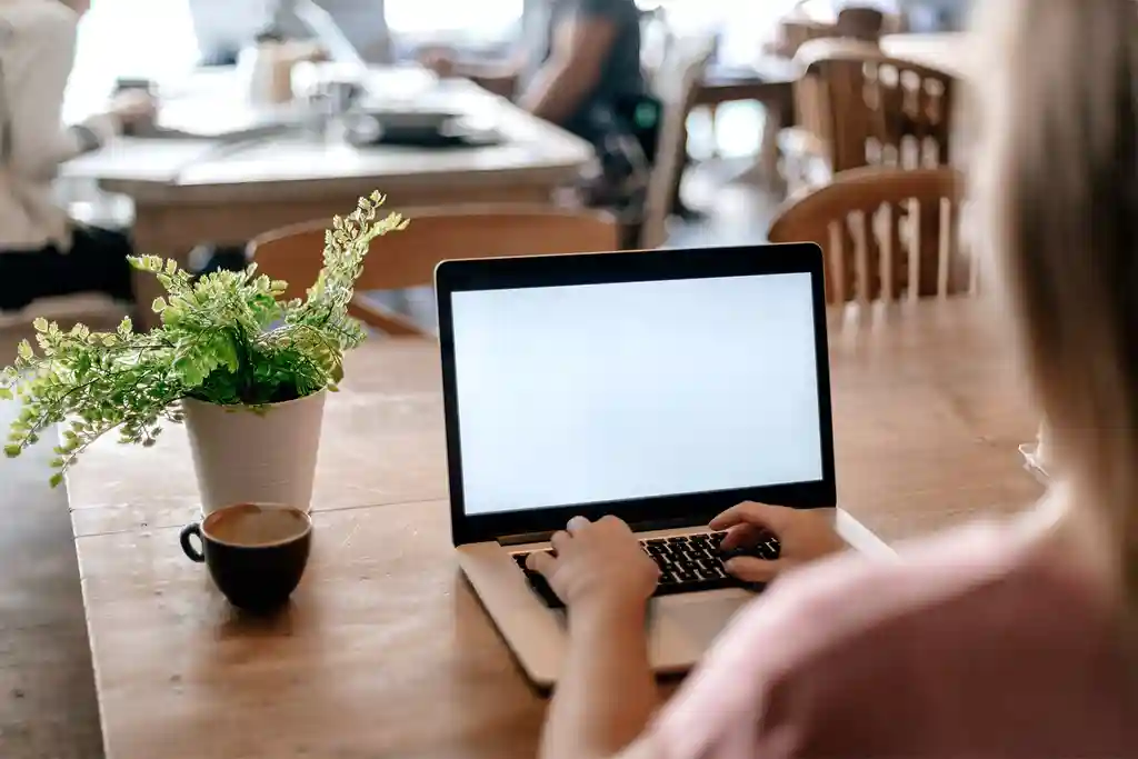 photo of woman sitting in a cafe with laptop