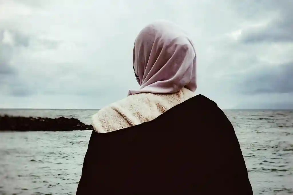 photo of woman looking at sea against sky