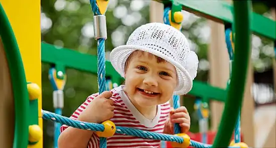 Happy two-year child in playground area