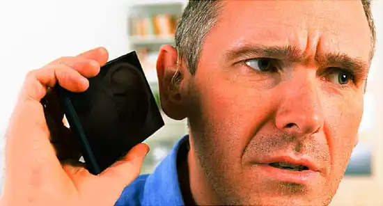 man straining to hear phone
