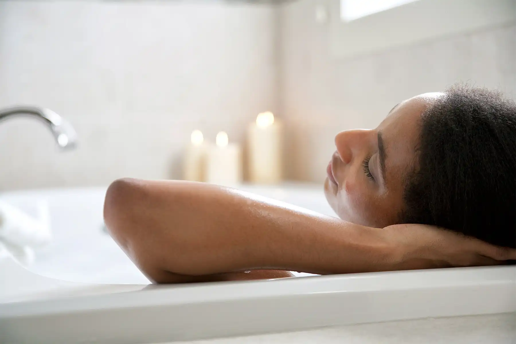 photo of woman soaking in bathtub