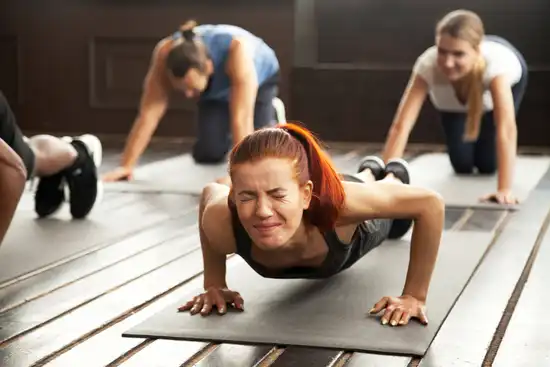 photo of woman doing challenging push-ups