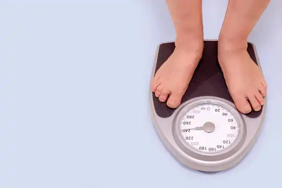 obese man standing on scale