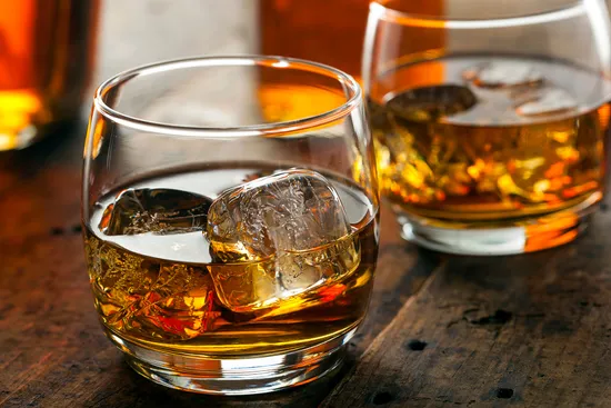 photo of glasses of bourbon on ice
