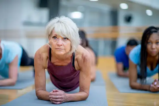 photo of mature woman doing yoga