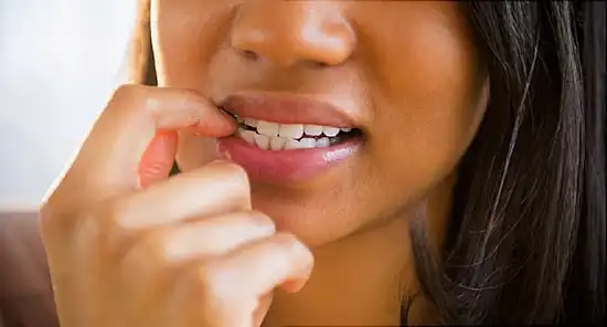 woman biting nails