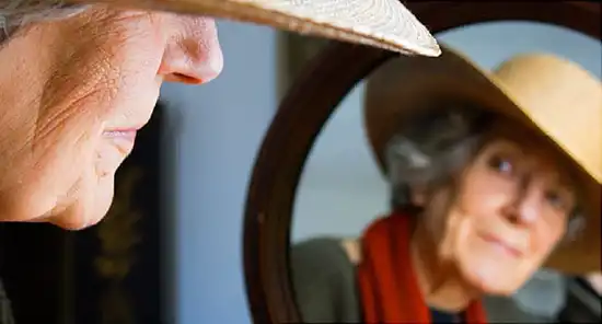 older woman in mirror