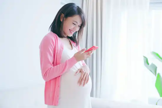 photo of pregnant woman on phone
