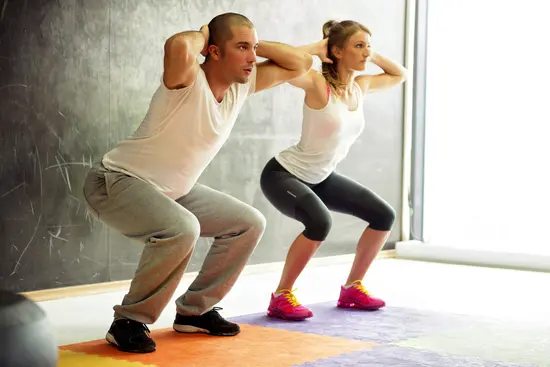photo of man and woman doing squats