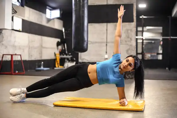 photo of woman doing side plank