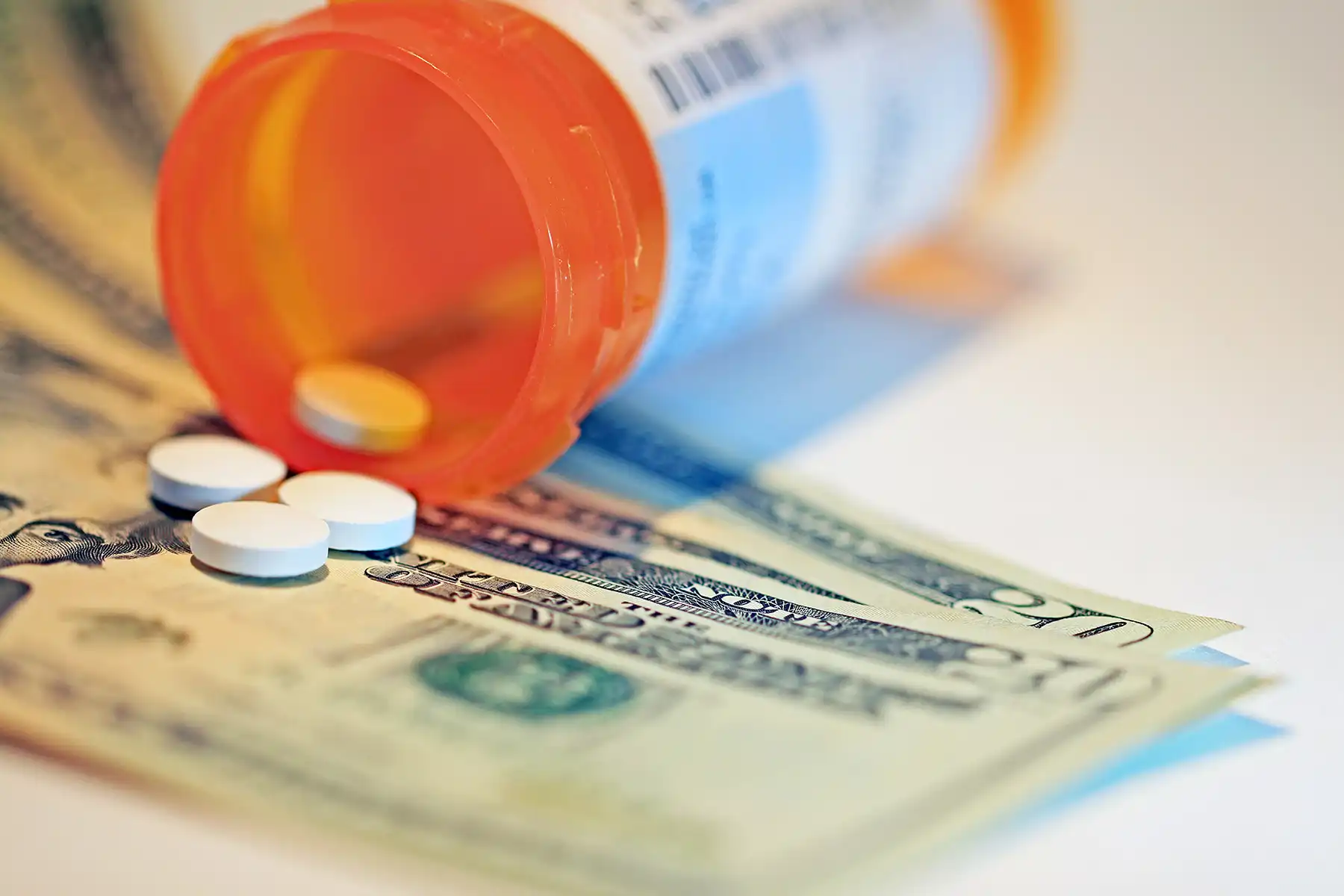 photo of prescription pills and $20 bills