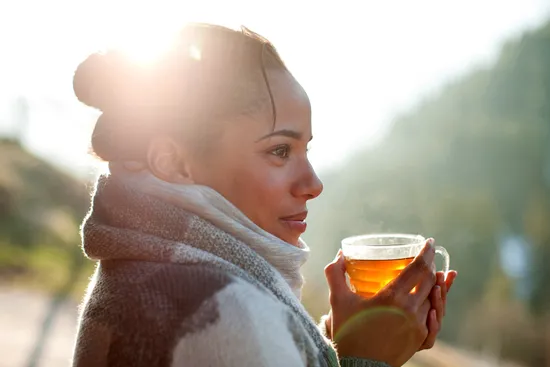 photo of woman drinking tea outside