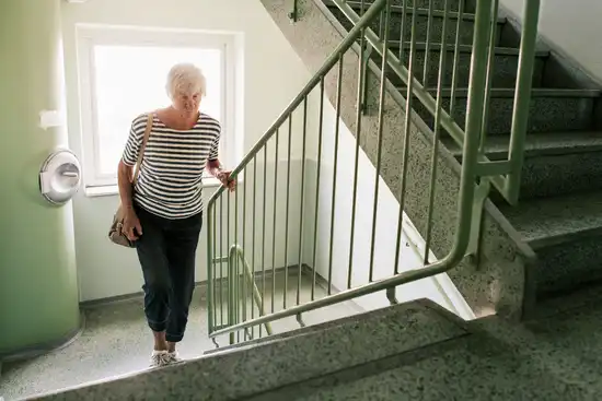 photo of senior woman climbing stairs