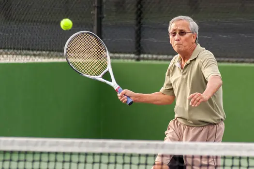photo of senior man playing tennis