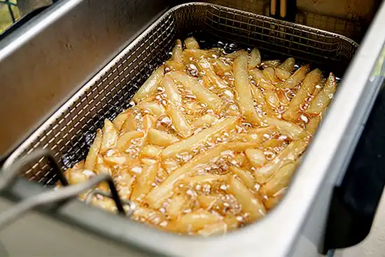 photo of French fries in deep fryer