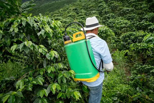 photo of worker spraying pesticides