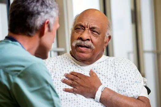 photo of patient describing chest pain to doctor