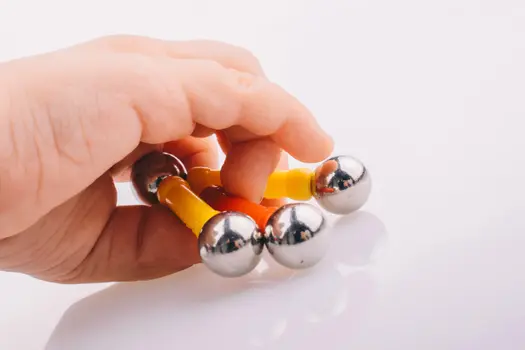 chilld's hand holding toy with magnets